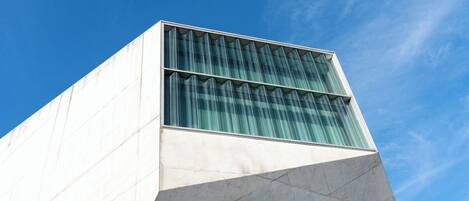 A modern building with a geometric facade and large glass windows.