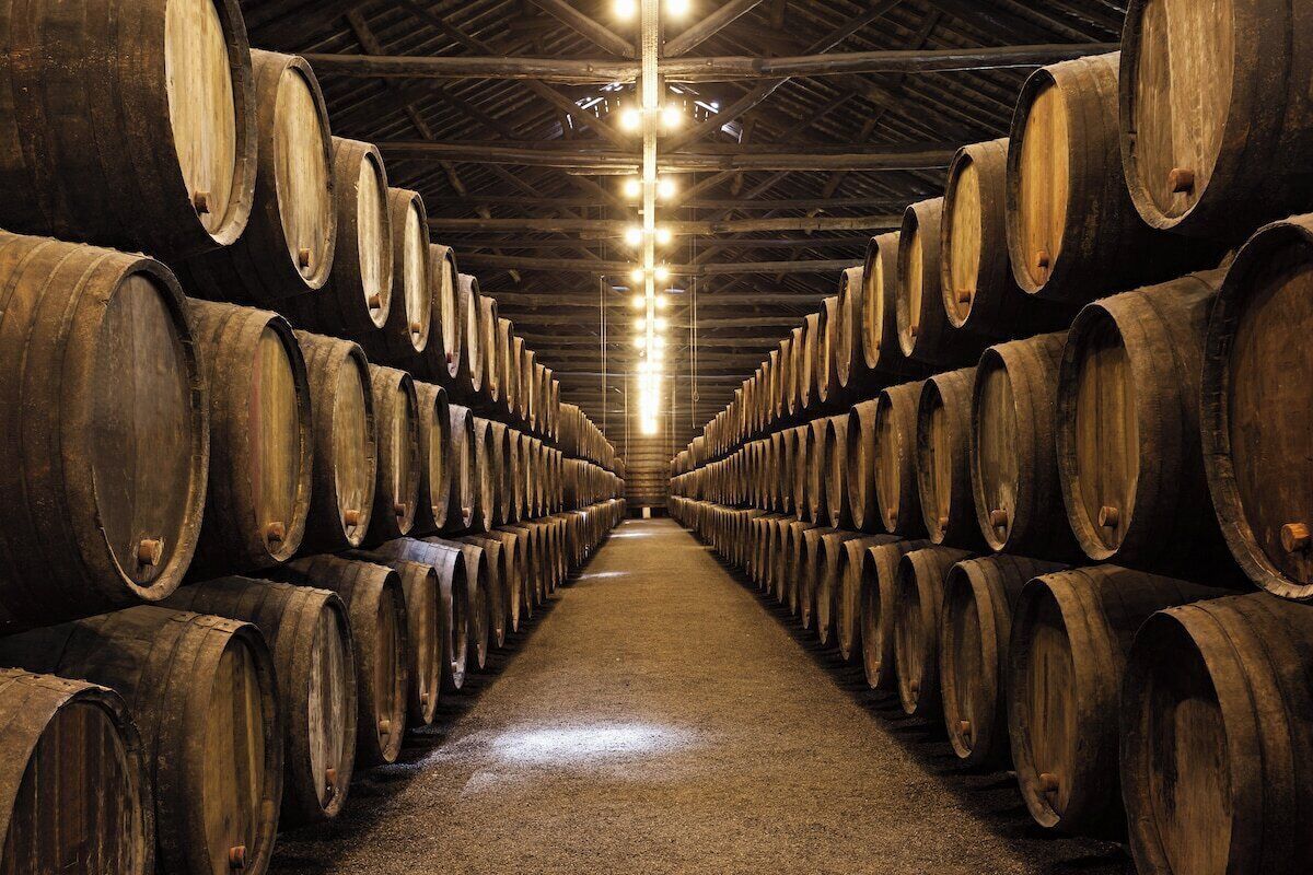 A warehouse with rows of wooden barrels.