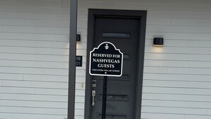 A sign indicating the property is reserved for guests of a specific establishment. - Serene 1-bedroom condo with full kitchen, bathroom and AC close to Vanderbilt. (Nashville)