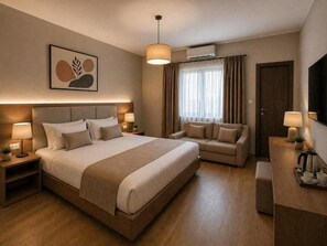 A hotel room with a large bed, a sofa, a desk with a lamp, and a TV. - Casa Del Sol SeaSide (Durrës)