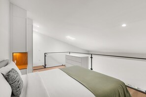 A modern bedroom with a bed, a nightstand, a wooden panel, and a balcony railing. - Oliveira do Douro Studio (Vila Nova de Gaia)