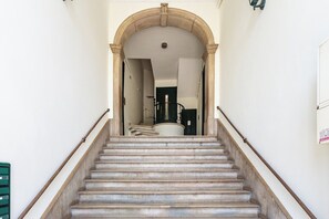 A staircase with a handrail, leading to a door at the top. - Bridge View Balcony, near LX Factory (Lisbon)