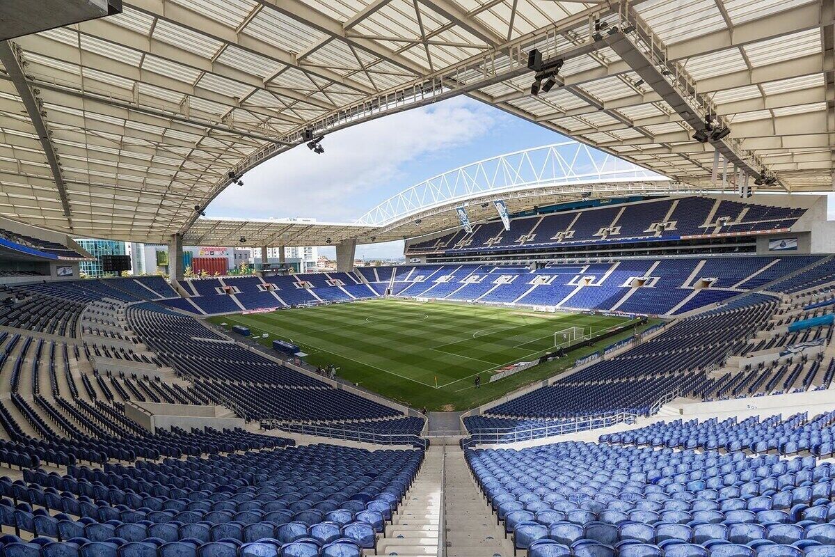 A stadium with tiered seating, a central field, and a large, covered spectator area.