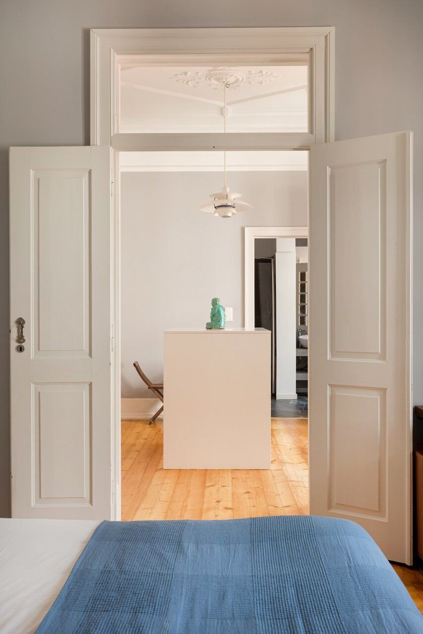 A room with a bed, a desk, and a chair.