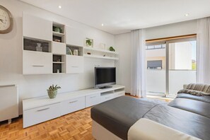A modern bedroom with a built-in TV, a large window, and a balcony. - Casa Magó (Espinho)