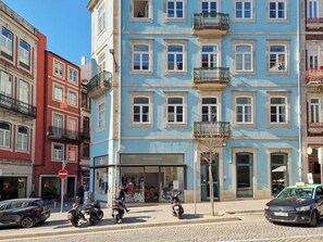 A multi-story building with a storefront labeled 'TYPOGRAPHIA' on the ground floor. - Inspiring City Center 1 BR Apartment with a View (Porto)