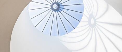 A modern architectural design with a circular structure and a central light fixture.