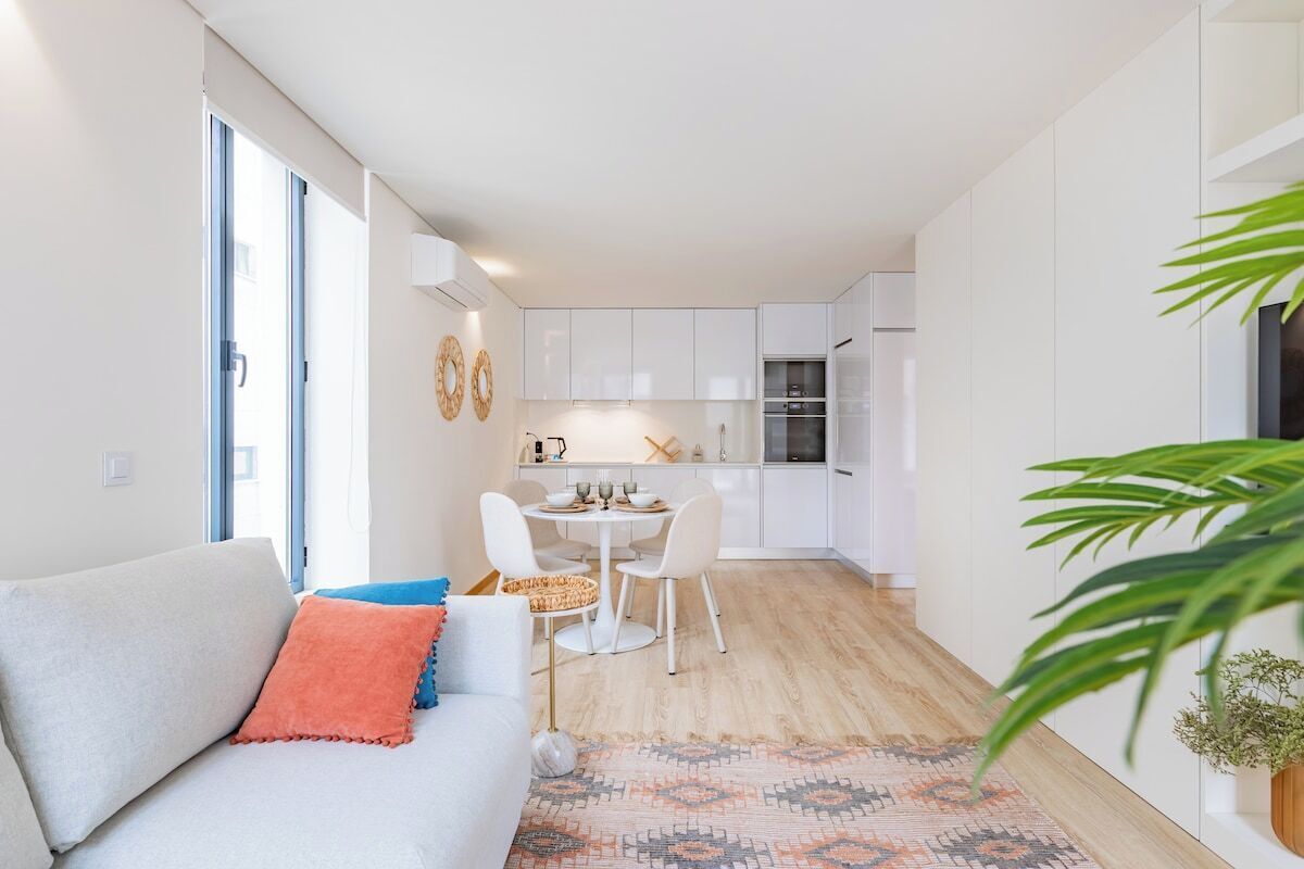 A modern apartment with a living area, a dining table, and a kitchen.