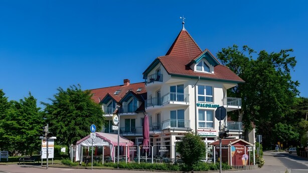 A multi-story building with a prominent sign reading 'WALDHAUS.' - Strandidyll Apartment with Balcony and Wi-Fi (Zempin)