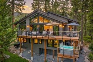 A modern two-story cabin with a balcony, a hot tub, and a deck. - Updated Tahoe Retreat | A/C & Hot Tub + Lake Views (Incline Village)