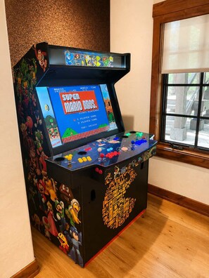 A retro gaming arcade machine with Mario Bros. game, featuring colorful graphics and game controls. - Escape to the heart of the Rockies! Luxury 5 bedroom home in Silverthorne! (Silverthorne)