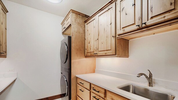 A kitchen with wooden cabinets, a stainless steel sink, and a built-in oven. - Escape to the heart of the Rockies! Luxury 5 bedroom home in Silverthorne! (Silverthorne)