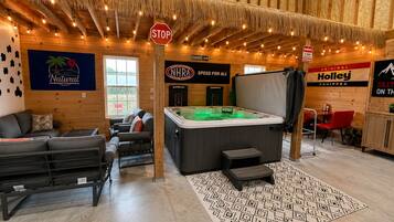 Un espace intérieur accueillant avec un jacuzzi, un canapé et un coin repas.