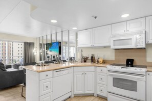 A modern kitchen with white cabinets, a built-in oven, and a microwave. - Ilikai Hotel | 2 Ocean view Studios, Sleeps 10 | Car Incl. w/ 6+ Nights | ML-4142 (Honolulu)
