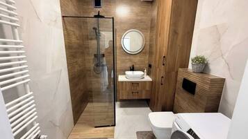 Deluxe Apartment, Patio, City View | Bathroom | Hair dryer, slippers, towels, soap
