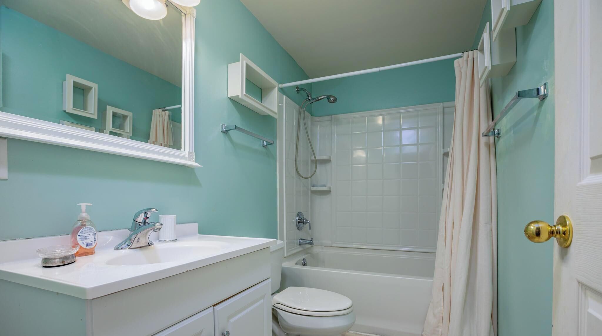 A bathroom with a white sink, a toilet, a shower, and a bathtub.