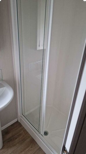 A glass-enclosed shower area with a white sink to the left. - Southview Holiday Park - Holiday Accommodation 21279 (Skegness)