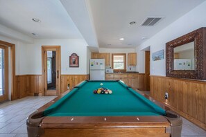A pool table with balls, wooden cabinets, a refrigerator, and a mirror. - 1925 - Lemon Cooler Your Corolla dream stay: 6BR, pool, hot tub, theater room & sunny decks. (Corolla)