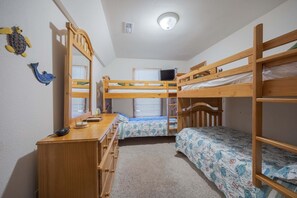 A bunk bed room with a desk, dresser, and a ceiling light. - 1925 - Lemon Cooler Your Corolla dream stay: 6BR, pool, hot tub, theater room & sunny decks. (Corolla)