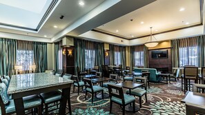 A hotel room with a dining area, a sofa, and a TV. - Accessible 1BR Suite w/ Breakfast Included & Pool (Laredo)