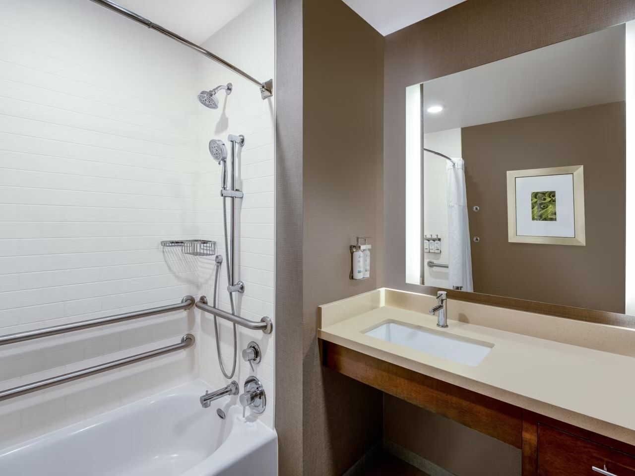 A bathroom with a bathtub, shower, and vanity with a sink and mirror.