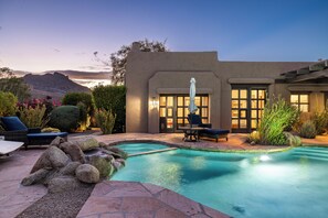 A pool area with lounge chairs and a stone pathway leading to the pool. - Luxury William Tull Desert Estate with Hidden Room (Carefree)
