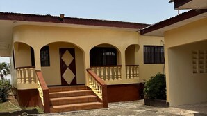 A two-story house with a central staircase, a balcony, and a garage.