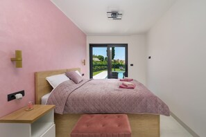 A bedroom with a bed, bedside table, and a view of a swimming pool. - Villa Luna Kanfanar (Istria - Kanfanar) (Kanfanar)