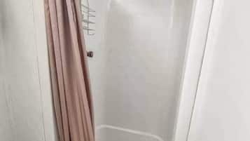 Shower, hair dryer, towels, shampoo