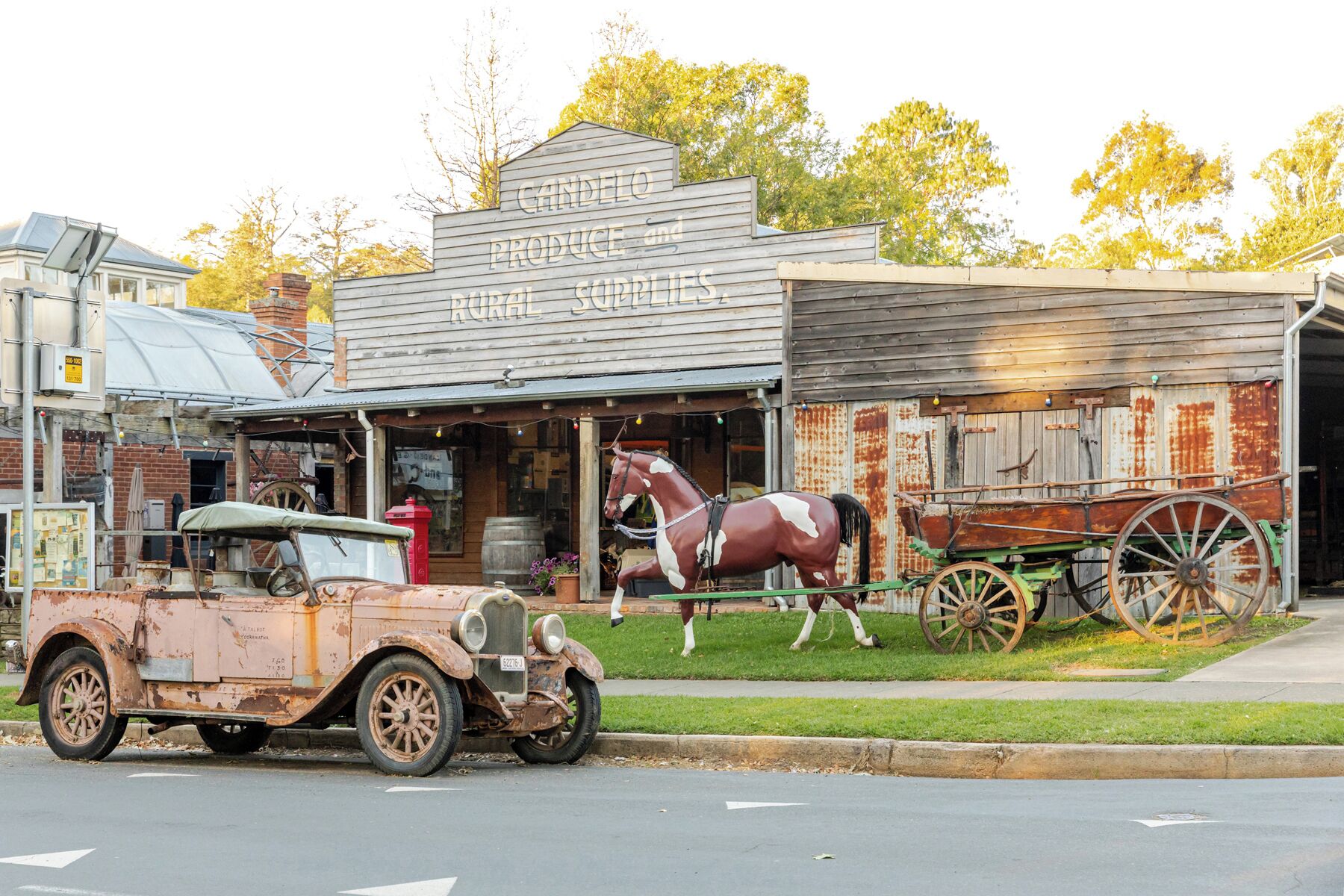 A rustic building with a sign reading 'CANDLEO PRODUCE AND RURAL SUPPLIES.'