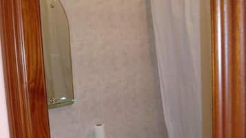 A bathroom with a toilet, sink, and shower curtain.