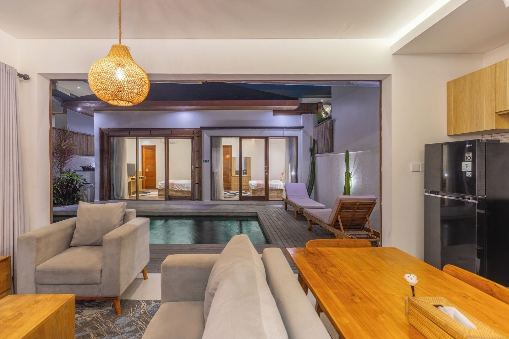 Open-concept living and dining space blending tropical and contemporary design.