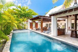 A swimming pool with lounge chairs and a covered area with a table and chairs. - The Annex - Private Villa - Large Pool and Jacuzzi (San Pedro)