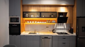 A modern kitchen with built-in appliances, a dishwasher, and a stainless steel refrigerator. - rose garden resort marrakech (Marrakech)