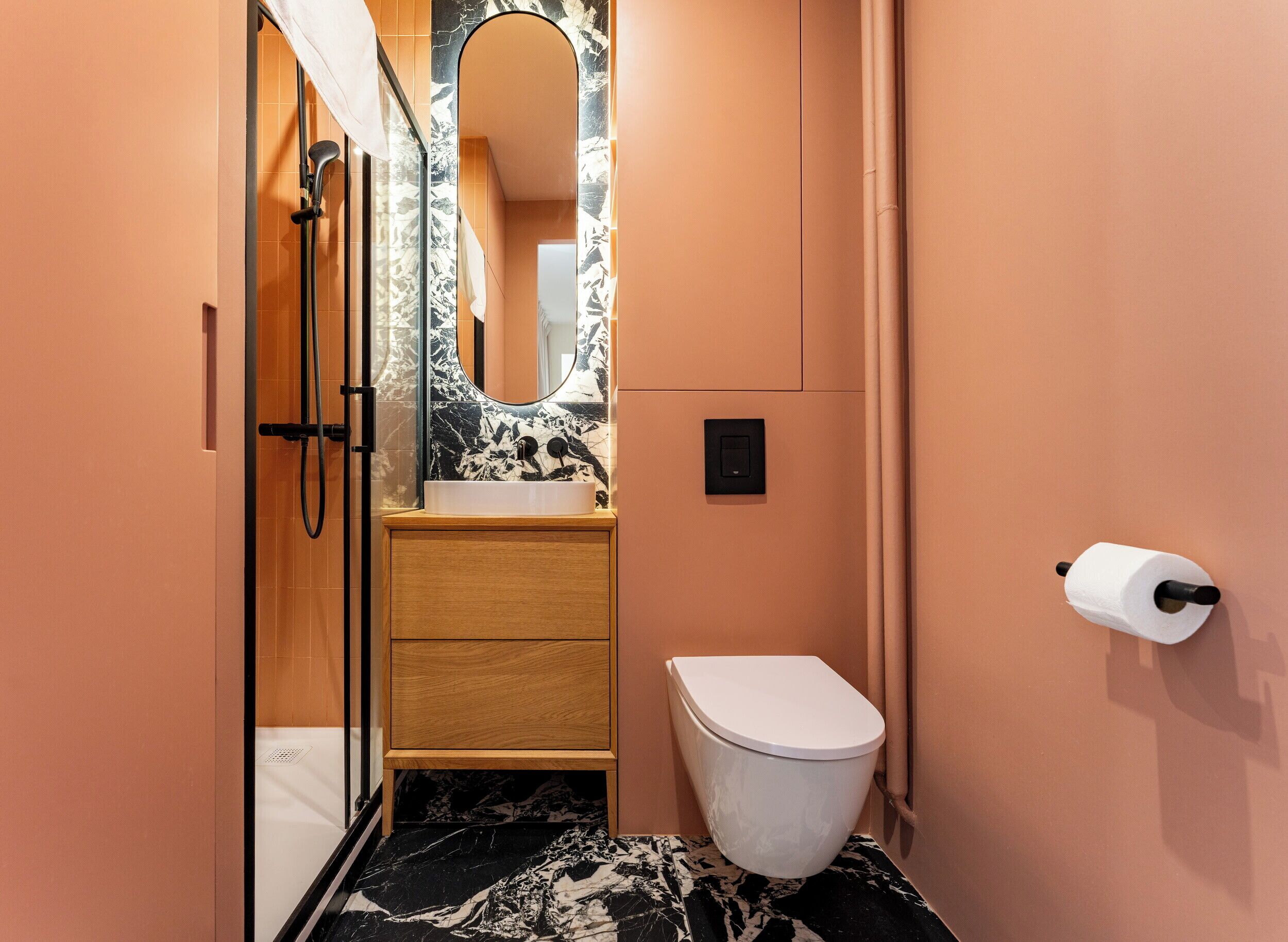 A bathroom with a shower, toilet, and sink.