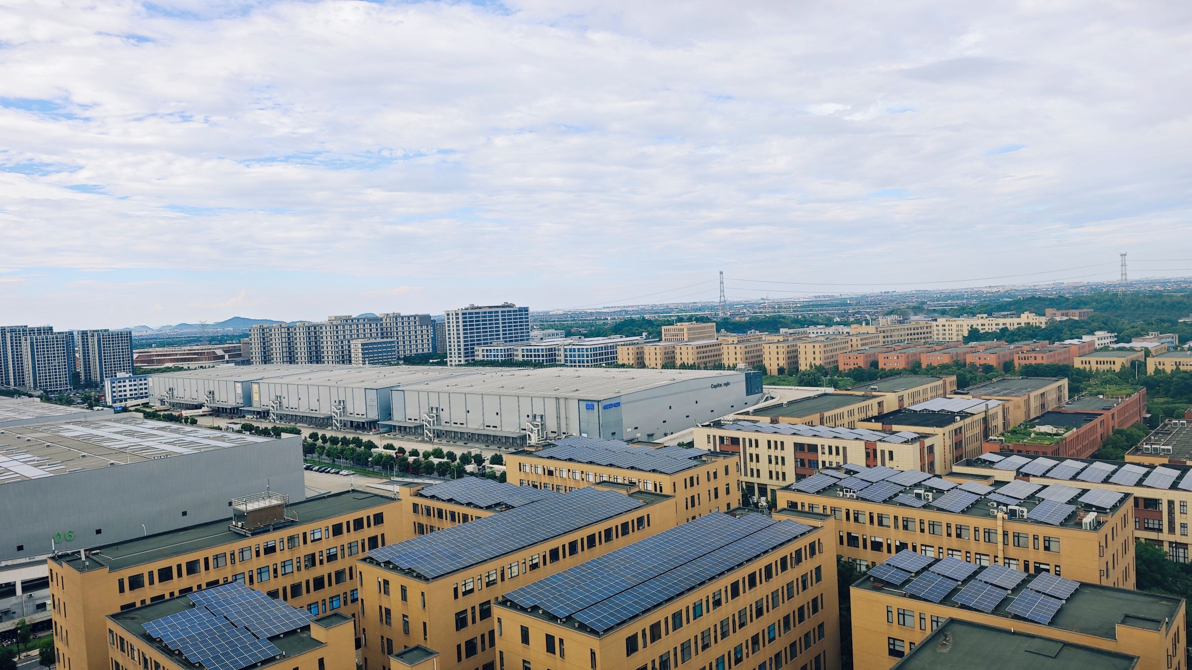 A high-rise building with multiple floors, large windows, and a flat roof.