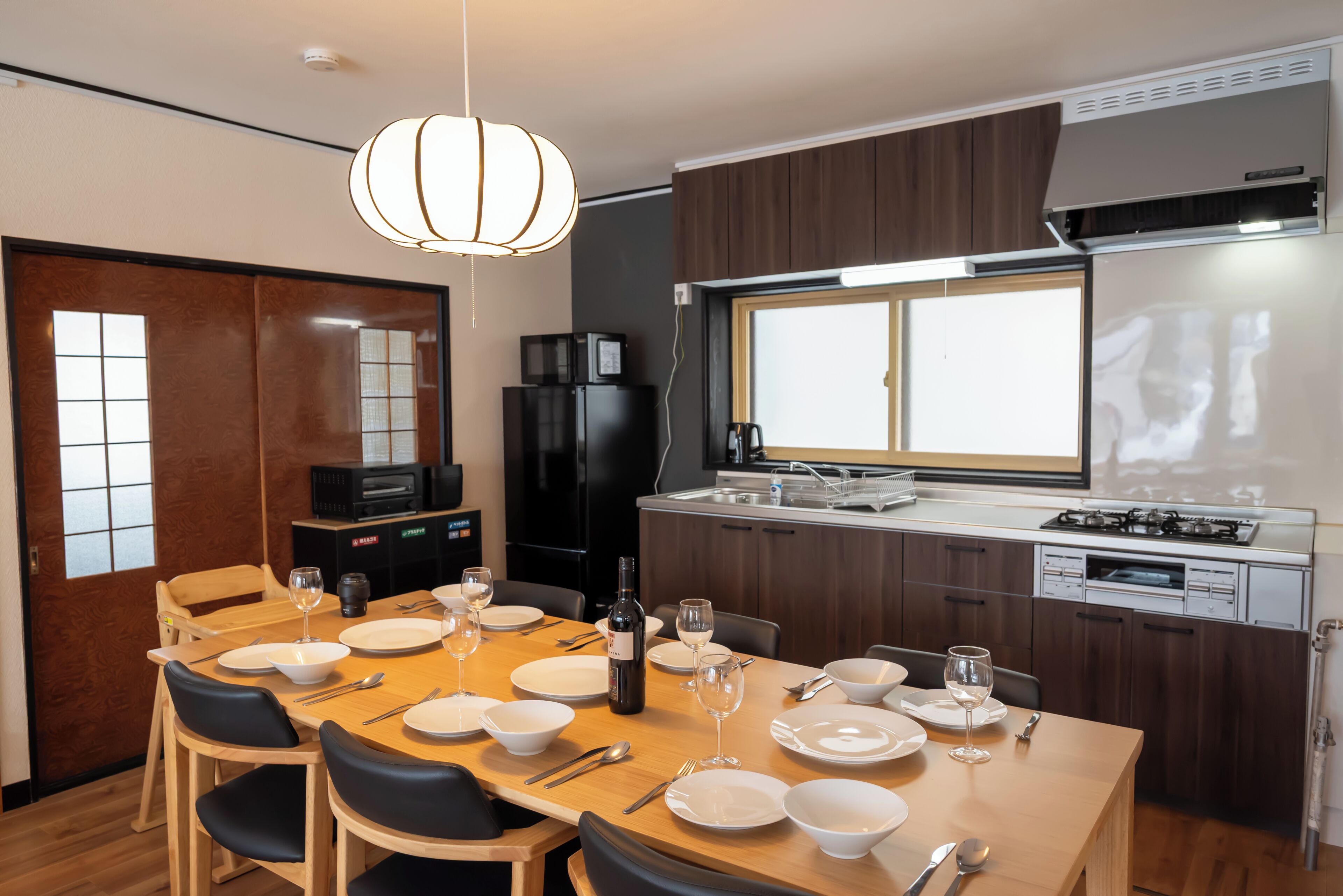 A modern kitchen with a dining area set for six.