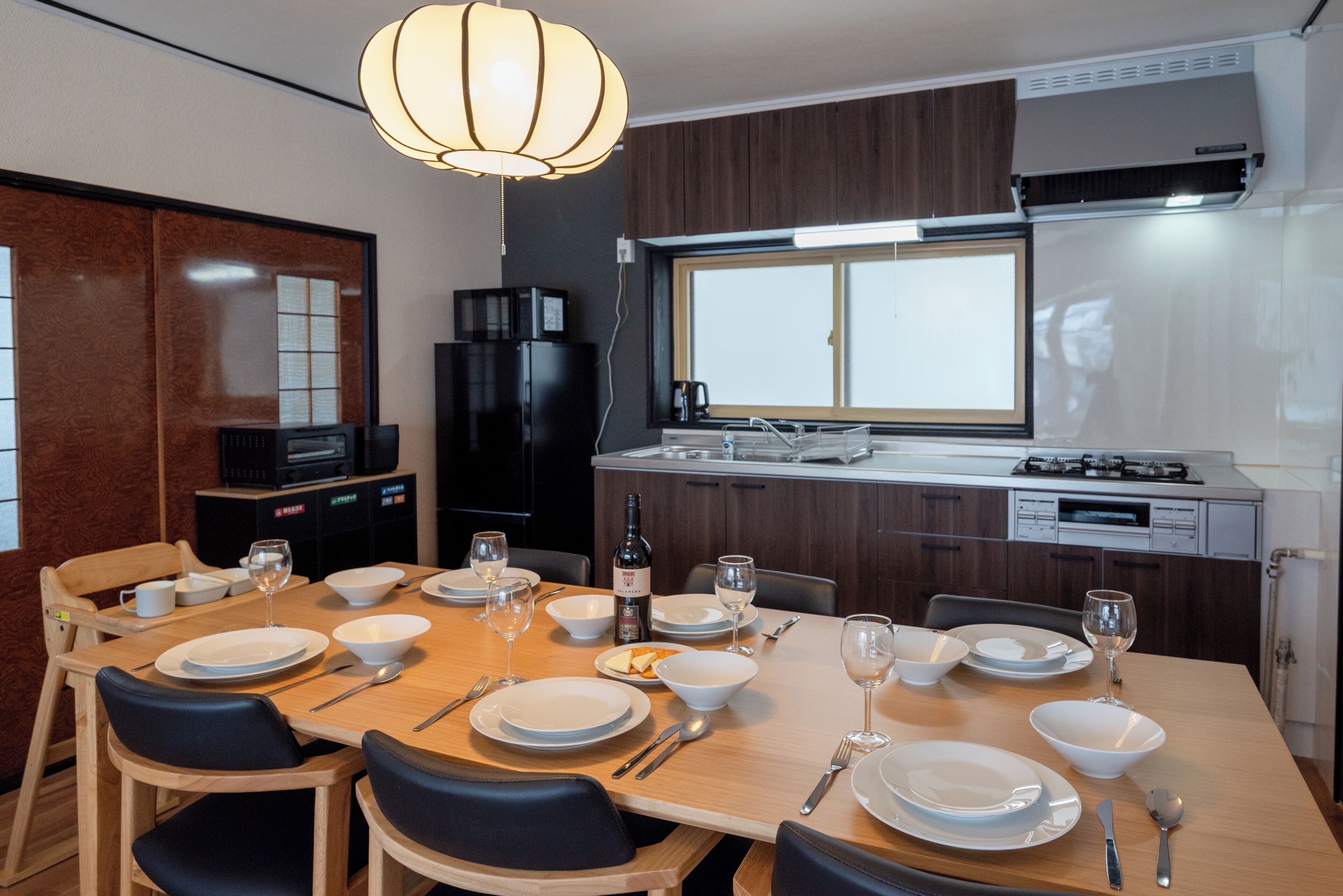 A modern kitchen with a dining area set for four.