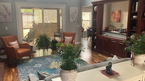 A spacious living area with a sofa, chairs, a coffee table, and potted plants. - Main level access = 2 BR, 2 private baths, and much more. Wheelchair accessible. (Braselton)