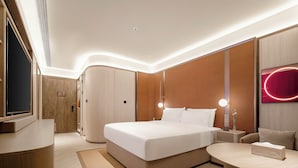 A modern hotel room with a large bed, bedside tables, a desk, and a flat-screen TV. - Crystal Hotel Hangzhou Binjiang Powerlong (Hangzhou)