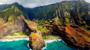 A coastal landscape with rugged cliffs and turquoise waters.