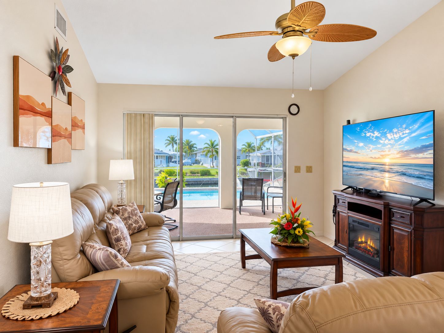 A living room with a sofa, a coffee table, a television, and a fireplace.
