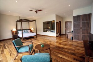 A hotel room with a four-poster bed, a sitting area with a round table, and a large window. - Oak Ray Tea Bush Ramboda (Ramboda)