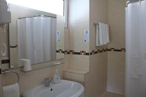 A bathroom with a sink, mirror, towel rack, and shower curtain. - Hotel Solar Das Laranjeiras (Vale de Cambra)