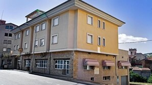 A multi-story building with a flat facade, several windows, and a ground-level entrance.