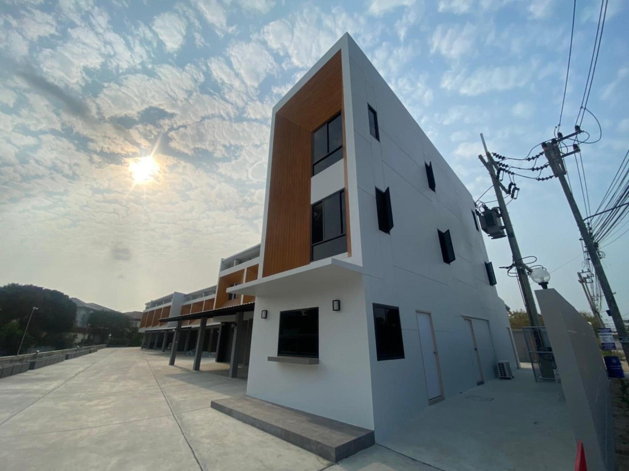 Un bâtiment moderne doté d’un toit plat, de nombreuses fenêtres et surplombant un ciel dégagé.