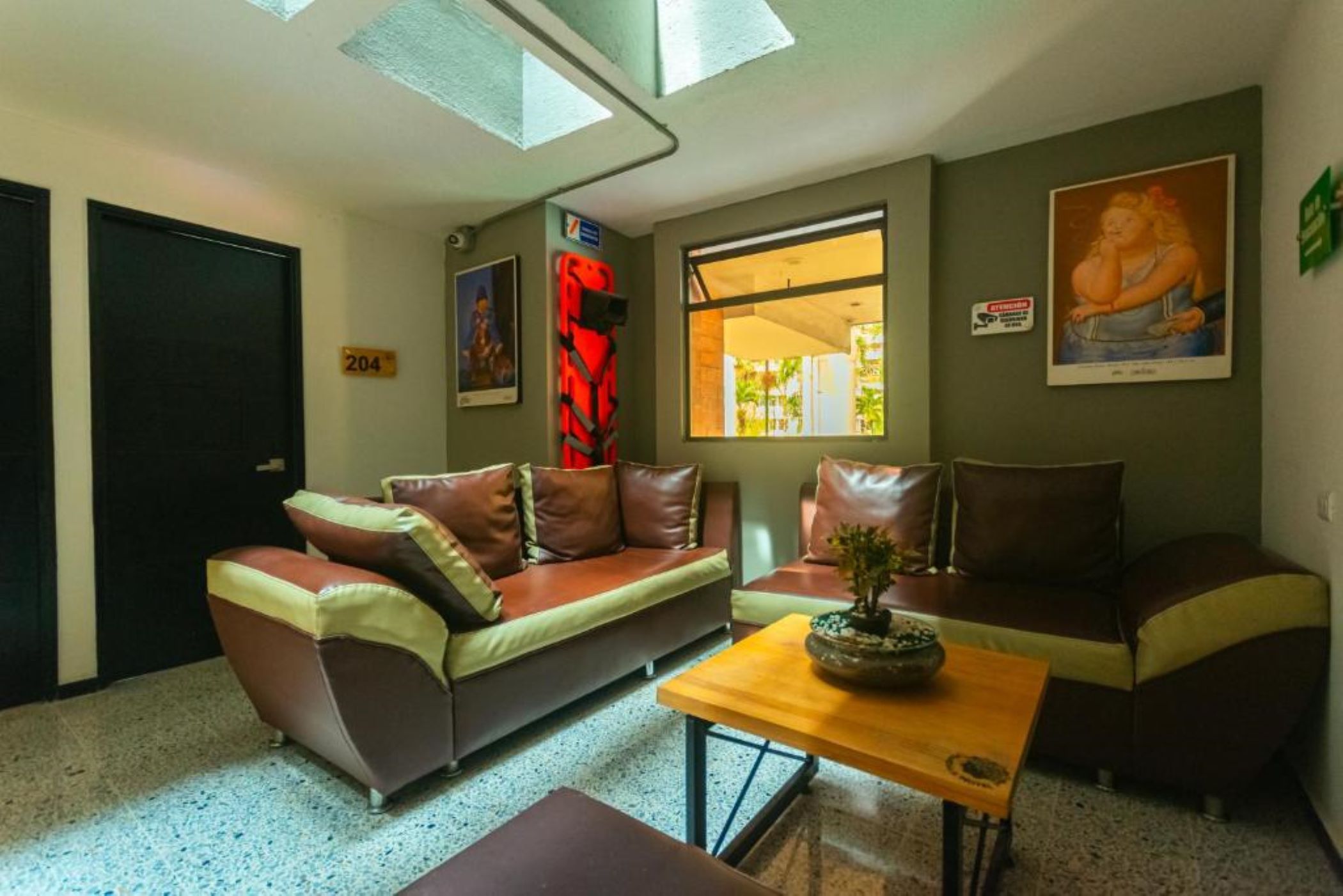 A living room with a sofa, a coffee table, and a window with a view.