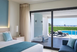 A hotel room with a large bed, a seating area with a view of the pool, and a balcony with a view of the sea.