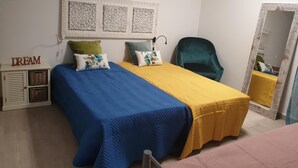 A bedroom with a bed, a chair, a wardrobe, and a mirror. - Lisbon Hostel Terminal 4 (Lisbon)