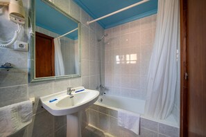 A bathroom with a white sink, a mirror, a shower, and a bathtub. - Hotel Buigues (Teulada)